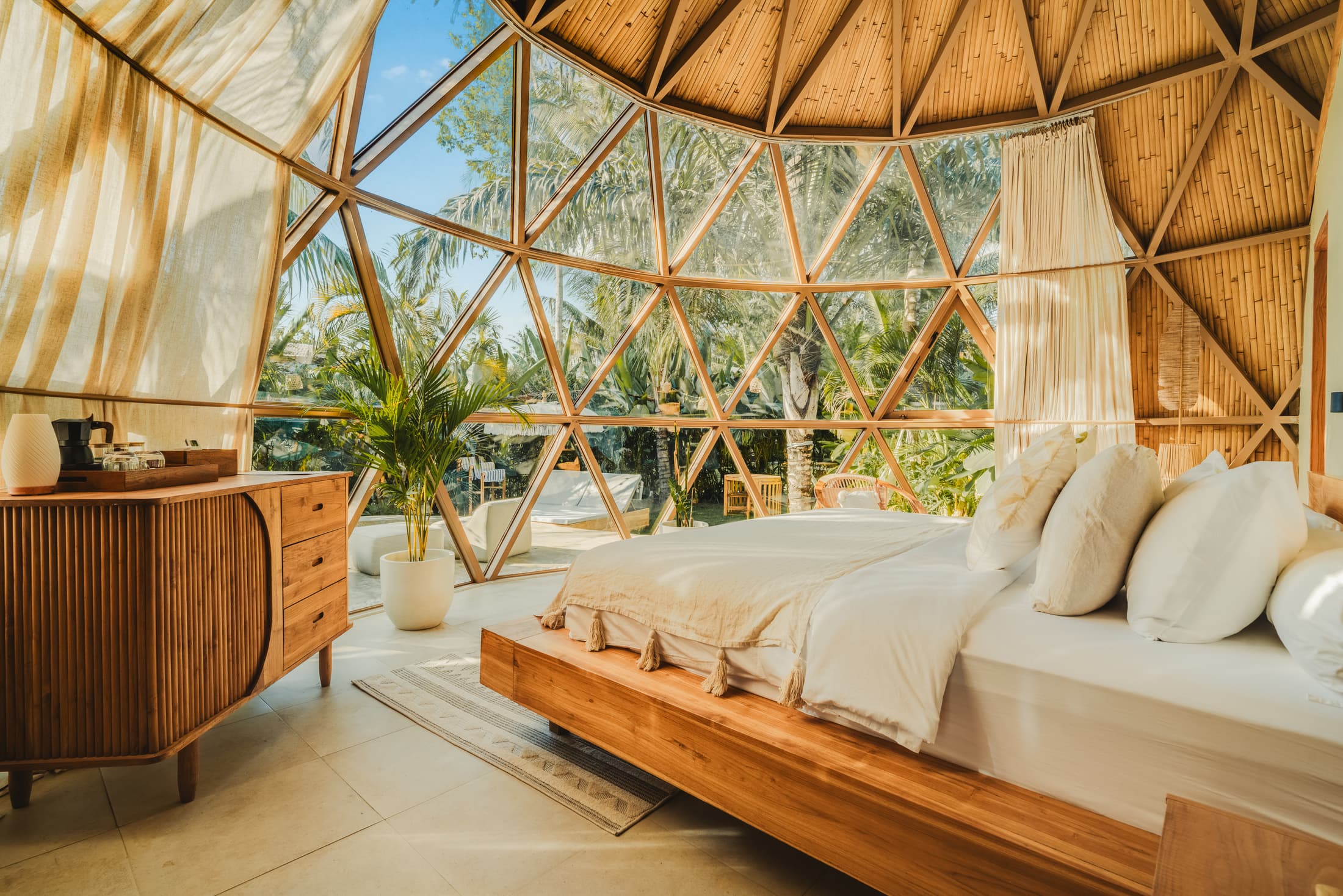 A bed under the timber frame of a dome