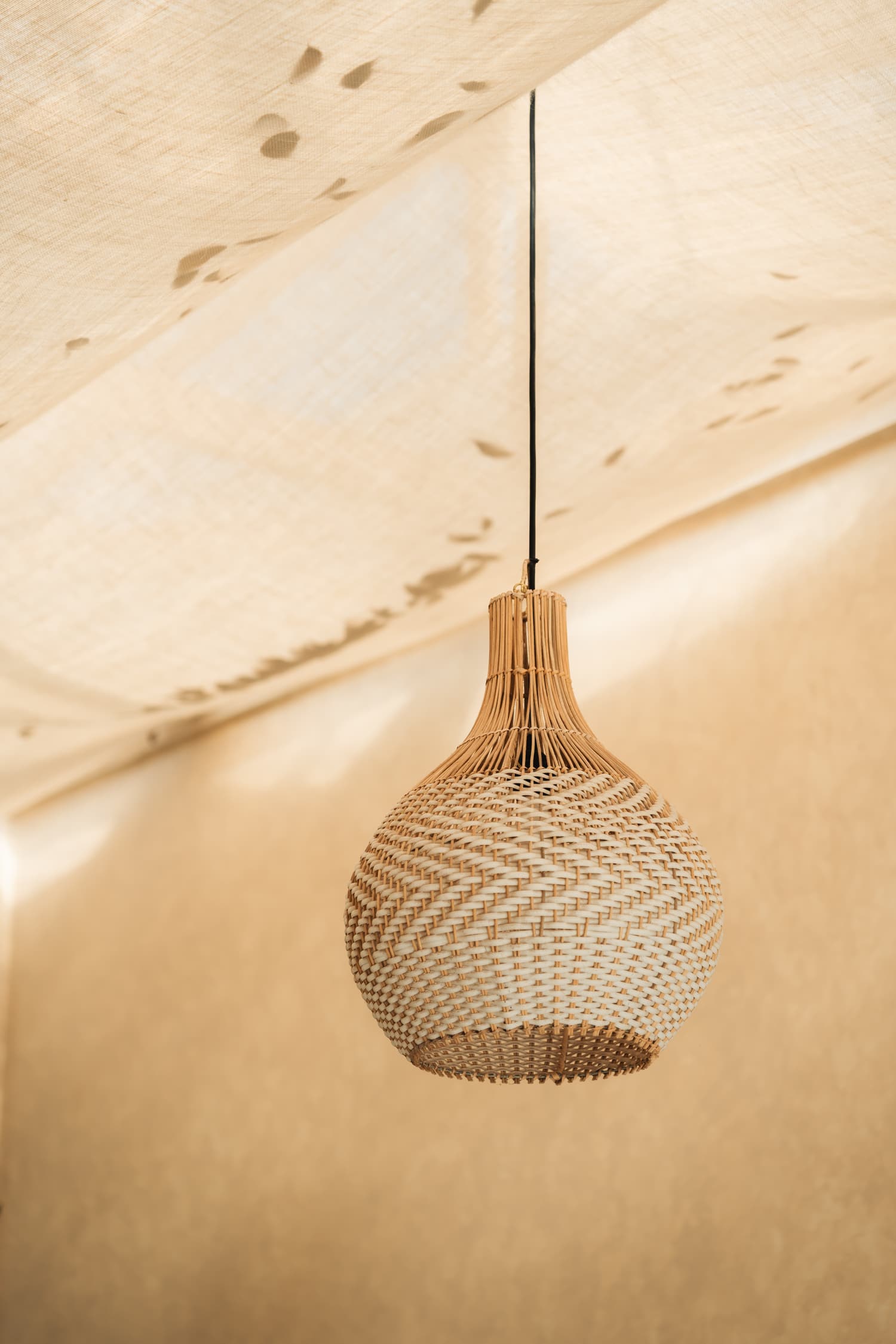 Woven rattan lamp in warm afternoon light